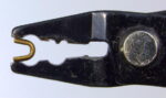 Properly placing the zip fastener top stop into the crimping pliers