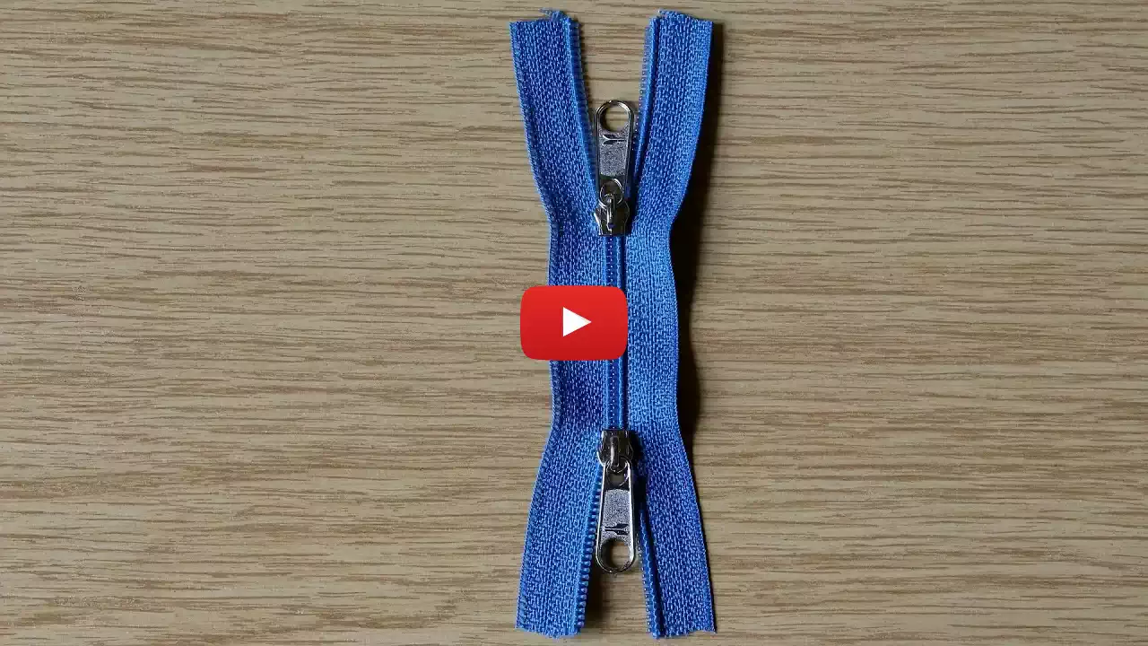 Start image for VideoPulling 2 sliders in opposite directions on a zipper chain so that it opens to form an X